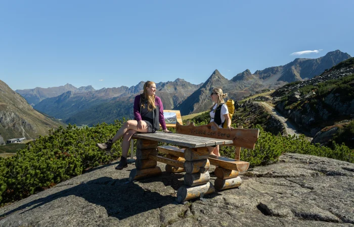 Woman sitting at a table with a view of the mountains