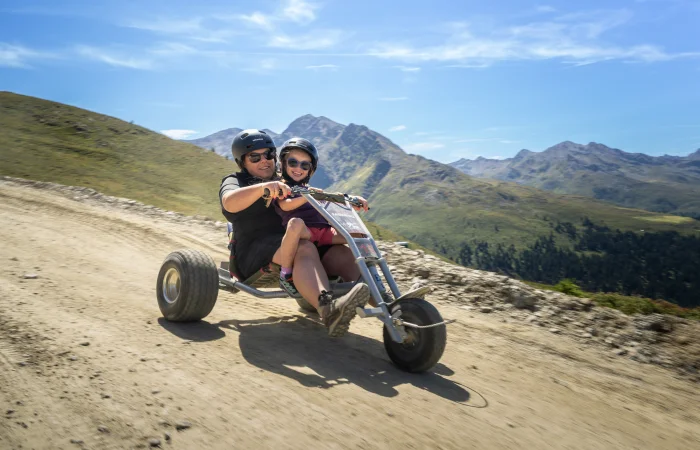 Father and child riding a mountain cart
