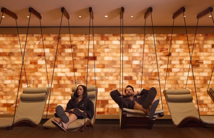 Couple lying on hanging chairs