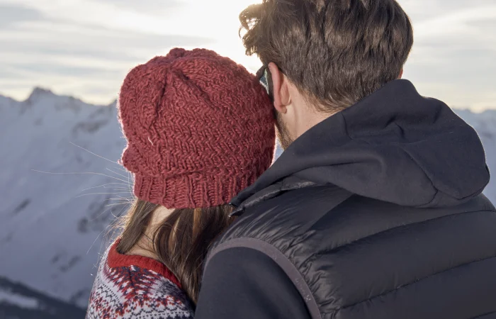 A couple in front of a mountain panoram